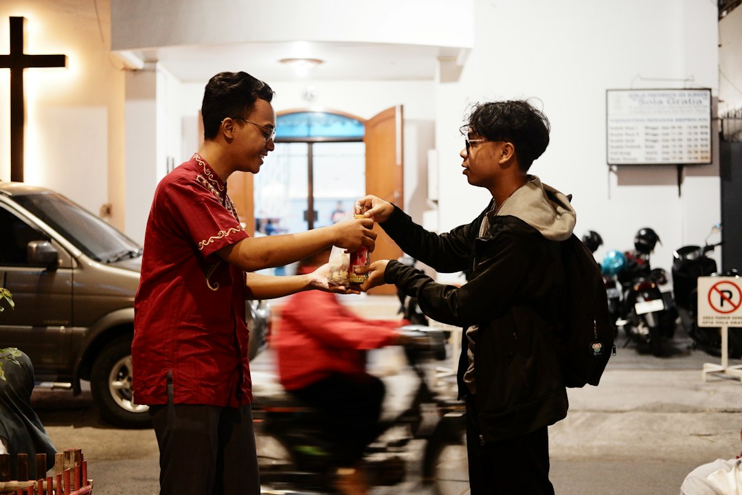 People sharing food, representing the corporal work of mercy to feed the hungry.