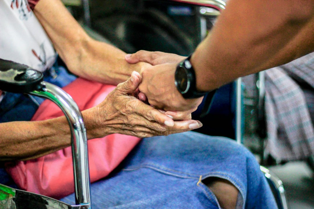A compassionate visit with an elderly person, representing the corporal work of mercy to visit the sick.